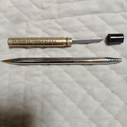 A.T. Cross silver and gold ballpoint pen made in USA shown with replacement refill