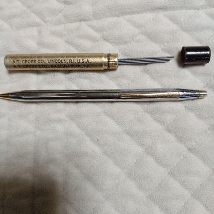 A.T. Cross silver and gold ballpoint pen made in USA shown with replacement refill