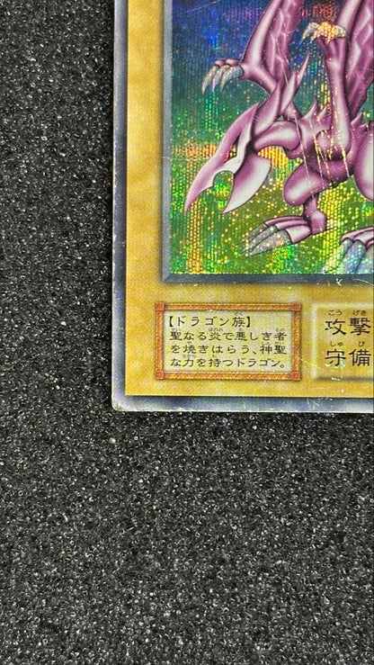 Bandai Holy Night Dragon Secret Rare Yu-Gi-Oh! card with battle-worn condition, Japanese edition