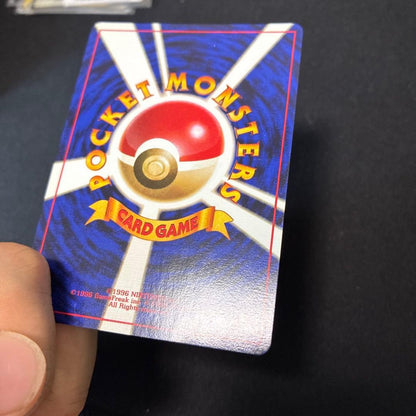 Lizardon First Edition old collectible card with no marks, shown in close-up