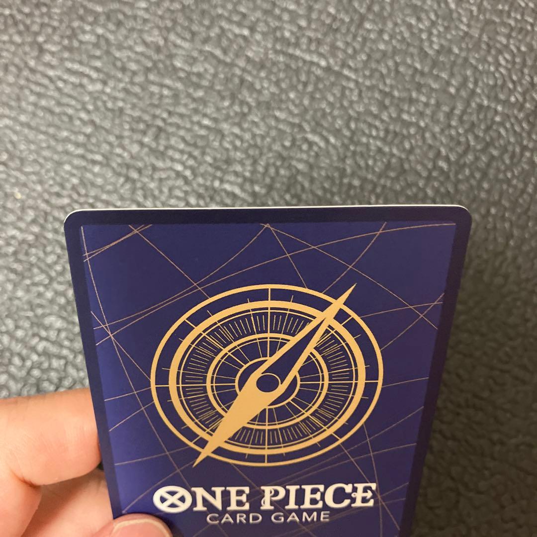 One Piece Nami SR Parallel card OP02-036 showing front design with visible wear and corner chip