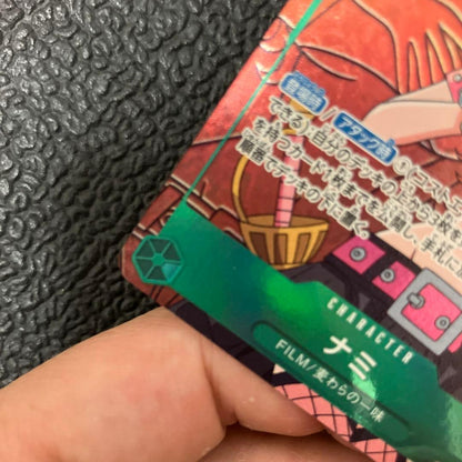 One Piece Nami SR Parallel card OP02-036 showing front design with visible wear and corner chip