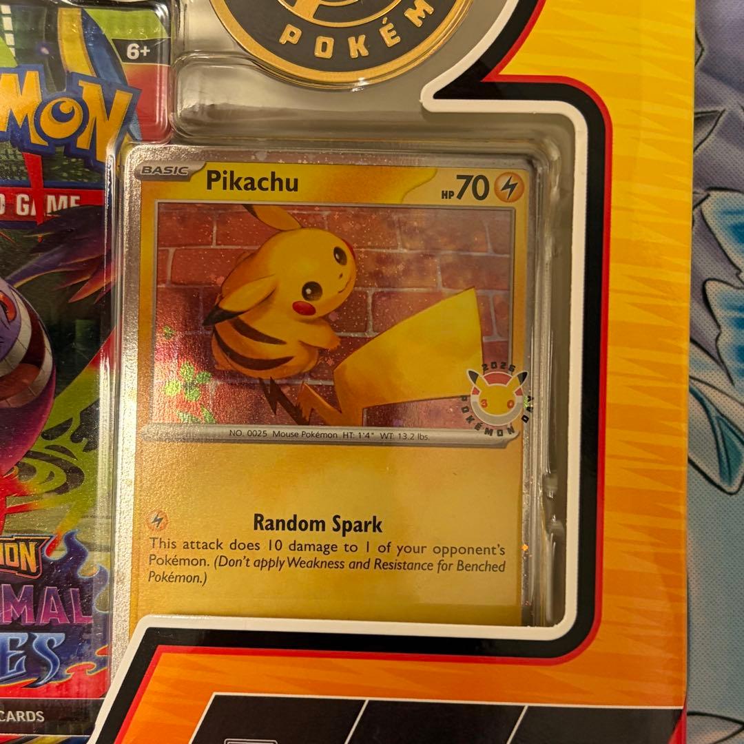 Pokemon Day 2026 Collection English version box with Pikachu promo card, coin, and three booster packs