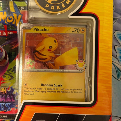 Pokemon Day 2026 Collection English version box with Pikachu promo card, coin, and three booster packs