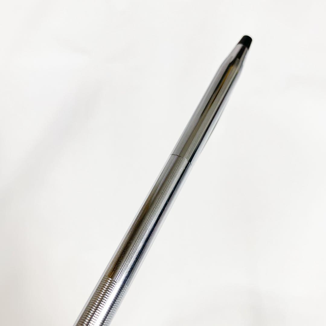 Used Cross brand silver ballpoint pen with blue ink shown on a white background