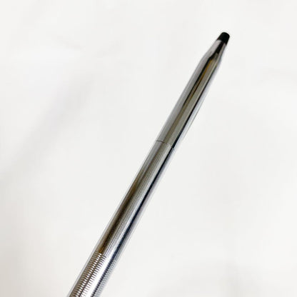 Used Cross brand silver ballpoint pen with blue ink shown on a white background