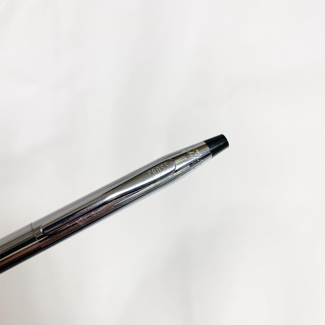 Used Cross brand silver ballpoint pen with blue ink shown on a white background