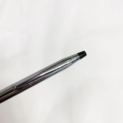 Used Cross brand silver ballpoint pen with blue ink shown on a white background