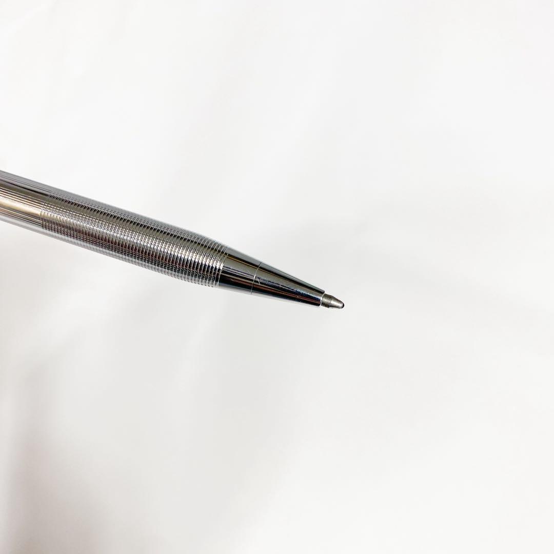 Used Cross brand silver ballpoint pen with blue ink shown on a white background