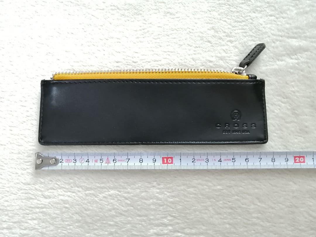 Cross brand leather pen case in used condition with visible scratches and stains