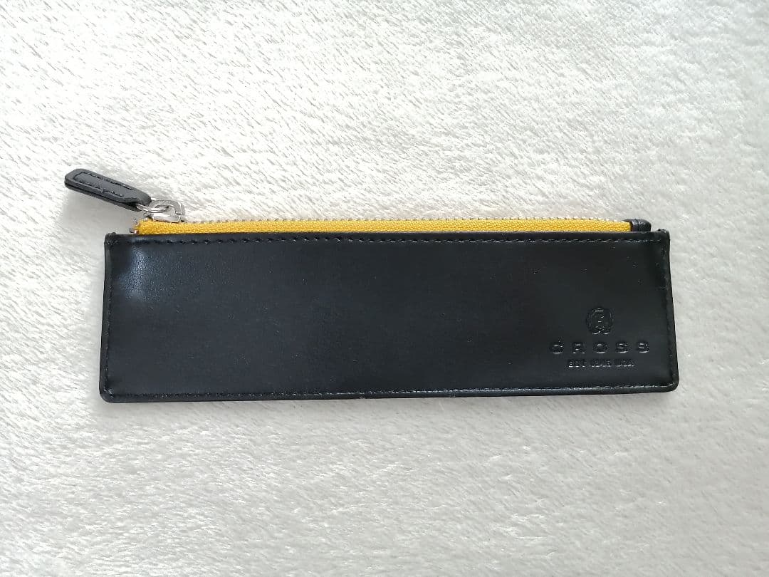 Cross brand leather pen case in used condition with visible scratches and stains