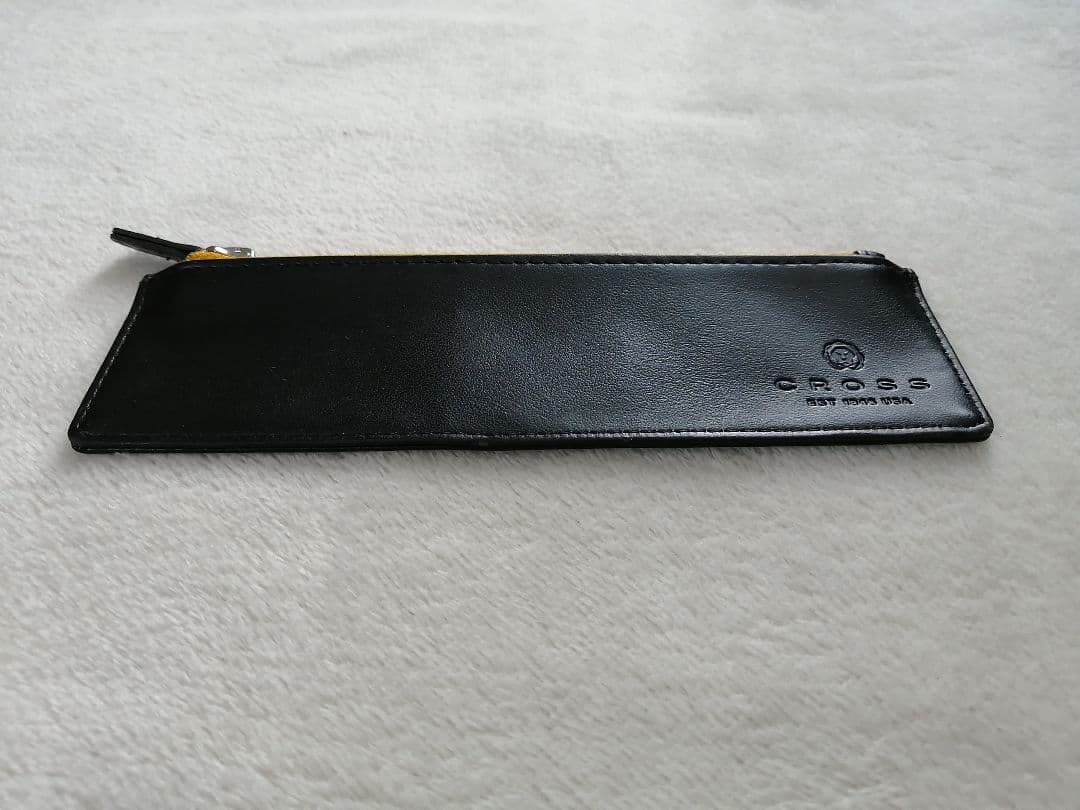 Cross brand leather pen case in used condition with visible scratches and stains