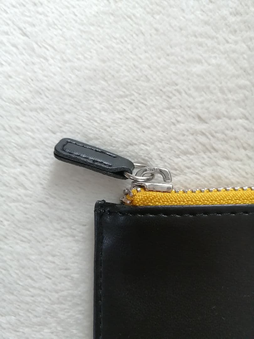 Cross brand leather pen case in used condition with visible scratches and stains