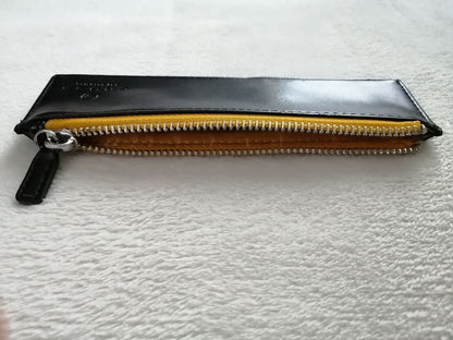 Cross brand leather pen case in used condition with visible scratches and stains