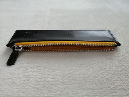 Cross brand leather pen case in used condition with visible scratches and stains