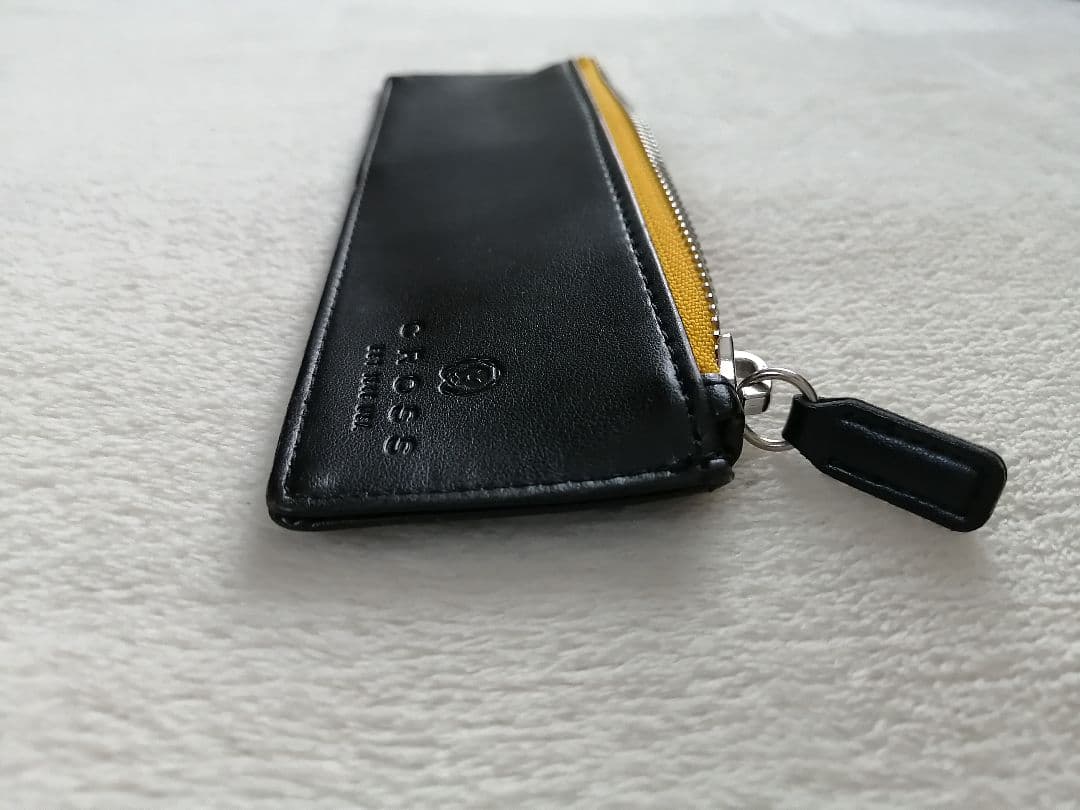 Cross brand leather pen case in used condition with visible scratches and stains
