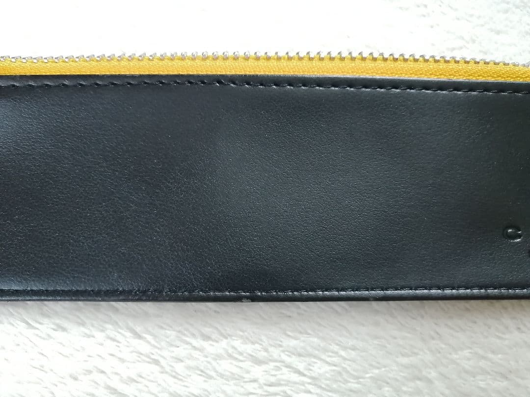 Cross brand leather pen case in used condition with visible scratches and stains