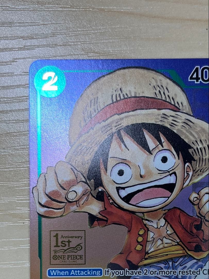 One Piece Monster D. Luffy 1st Anniversary Promo English version card with visible surface wear and white fade on the back