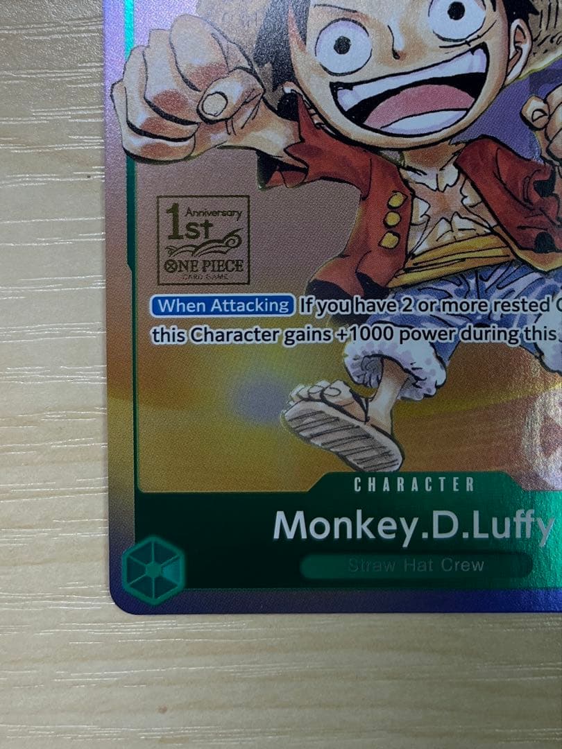 One Piece Monster D. Luffy 1st Anniversary Promo English version card with visible surface wear and white fade on the back