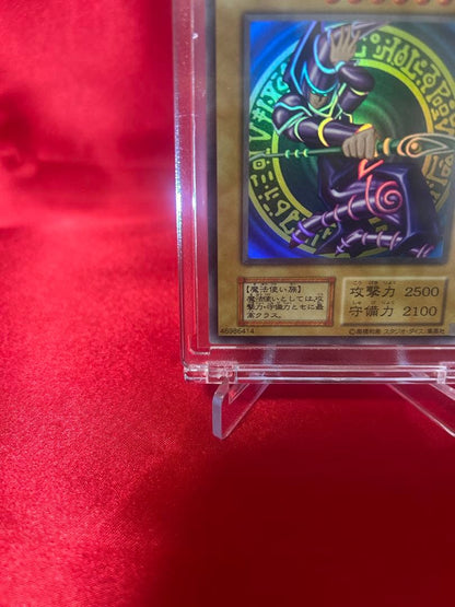 Yu-Gi-Oh Black Magician reprint card in sleeve and hard protective case