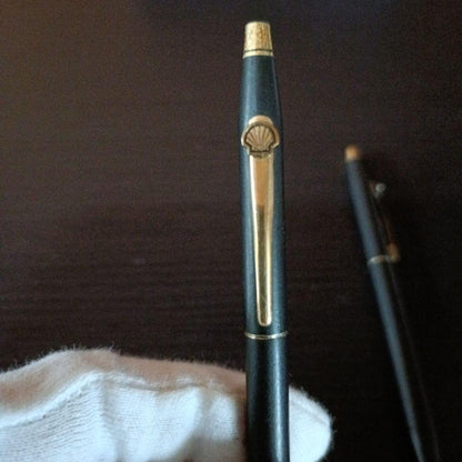 Cross twist ballpoint pen and mechanical pencil set in matte black with gold accents and shell logo