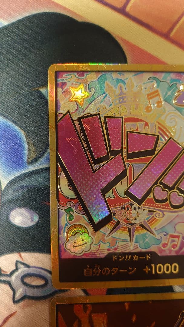 One Piece Card Game cards featuring Sabo, Luffy, Uta, and Akainu with gold borders in protective sleeve