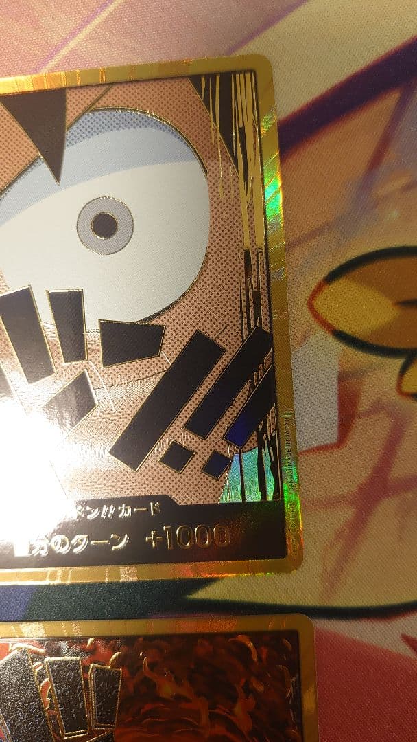 One Piece Card Game cards featuring Sabo, Luffy, Uta, and Akainu with gold borders in protective sleeve