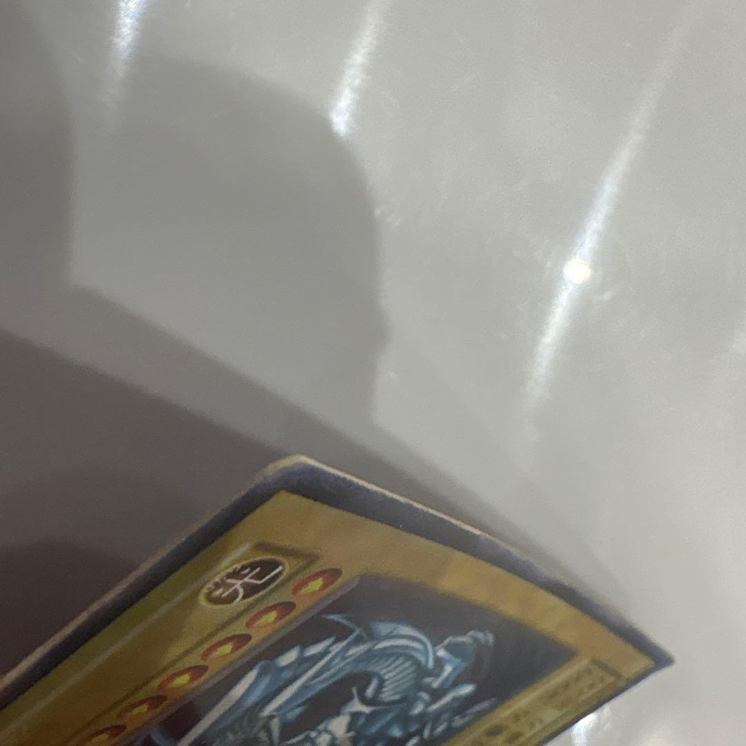 Yugioh Blue-Eyes White Dragon Ultra Rare Early Edition trading card showing signs of use and corner creases