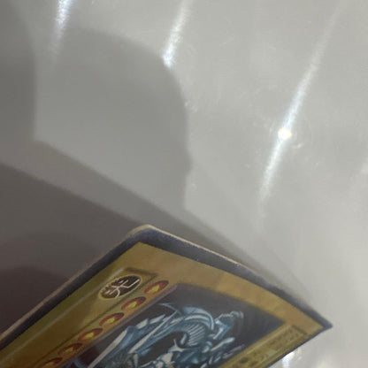Yugioh Blue-Eyes White Dragon Ultra Rare Early Edition trading card showing signs of use and corner creases