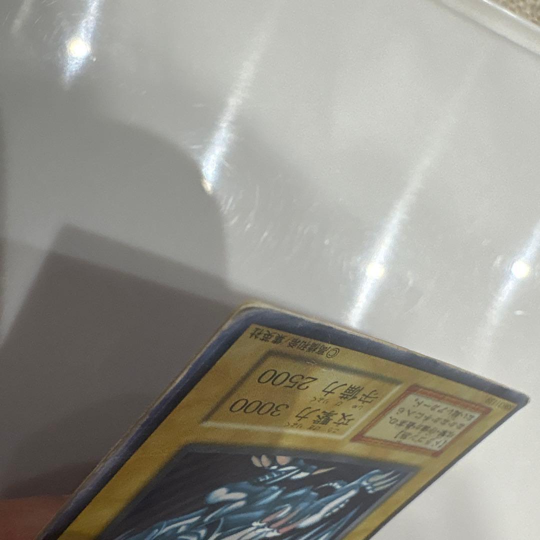 Yugioh Blue-Eyes White Dragon Ultra Rare Early Edition trading card showing signs of use and corner creases