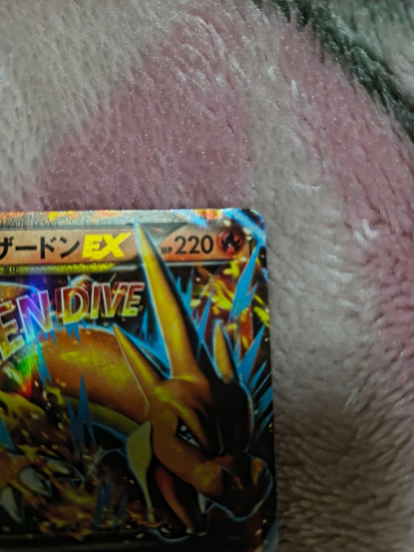 Mega Charizard Y Pokemon trading card sleeved for protection, authentic Japan import