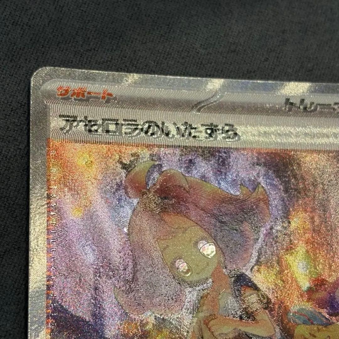 Asucola's Prank SAR 090/063 support card from Scarlet & Violet series with holo misalignment in bottom right corner