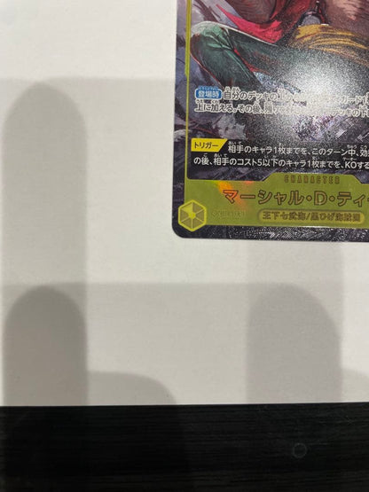 One Piece Marshall D. Teach collectible card in protective sleeve and case showing minor wear