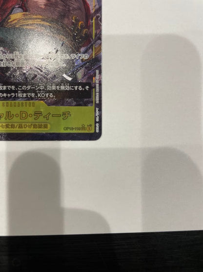 One Piece Marshall D. Teach collectible card in protective sleeve and case showing minor wear