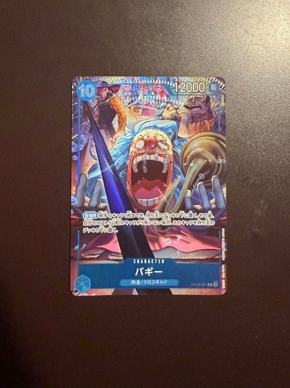 One Piece Buggy Character Card OP09-051 in protective sleeve with no visible scratches or stains