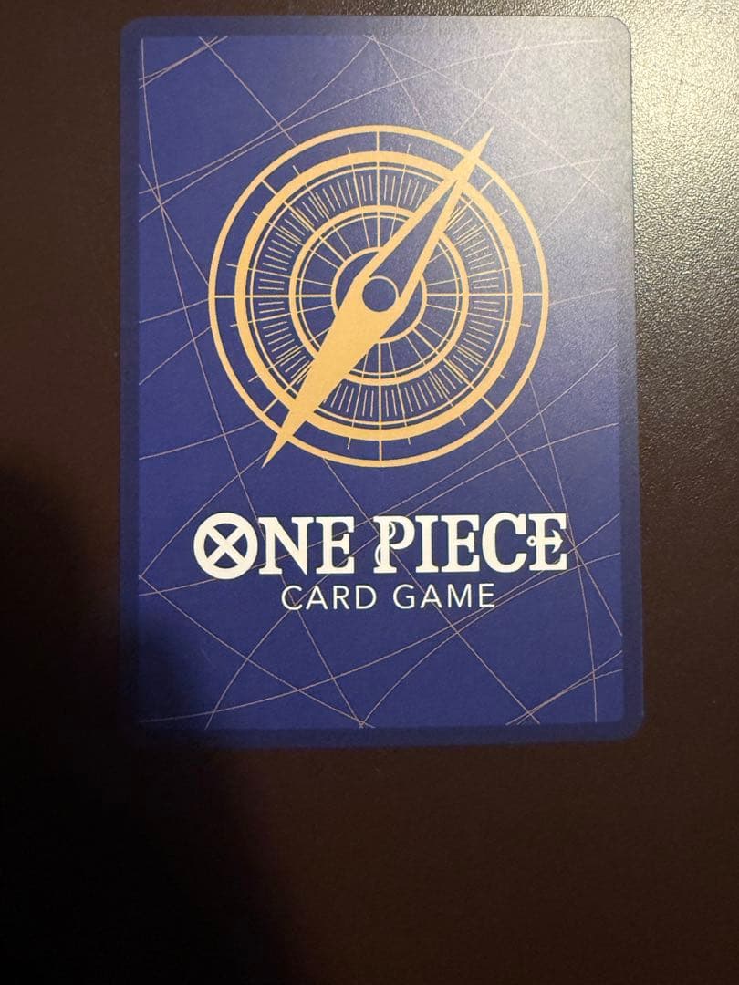 One Piece Buggy Character Card OP09-051 in protective sleeve with no visible scratches or stains