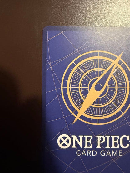 One Piece Buggy Character Card OP09-051 in protective sleeve with no visible scratches or stains