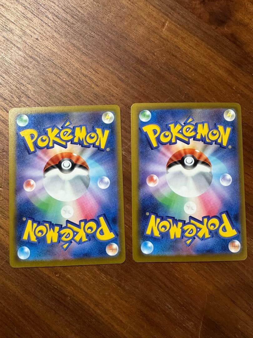 Pokemon card set featuring Mega Charizard X ex MA and Mega Gengar ex MA cards in protective sleeves