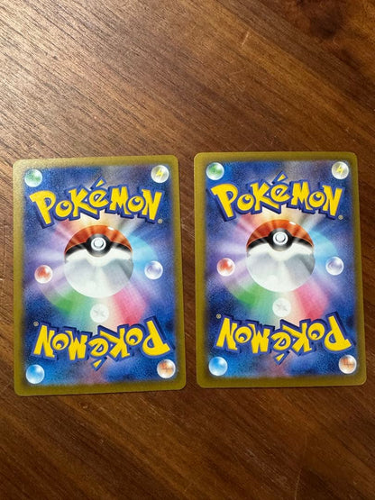Pokemon card set featuring Mega Charizard X ex MA and Mega Gengar ex MA cards in protective sleeves
