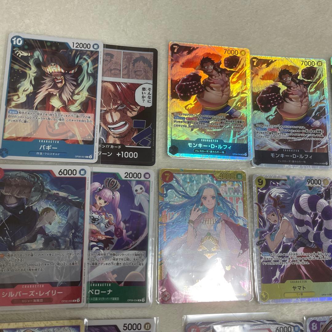 One Piece card set with Monkey D. Luffy SR, Sabo SR, Shanks R, and other rare cards in protective sleeves