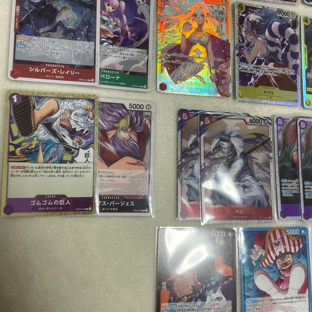 One Piece card set with Monkey D. Luffy SR, Sabo SR, Shanks R, and other rare cards in protective sleeves