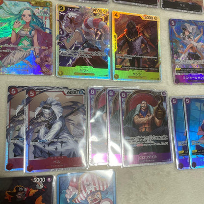One Piece card set with Monkey D. Luffy SR, Sabo SR, Shanks R, and other rare cards in protective sleeves