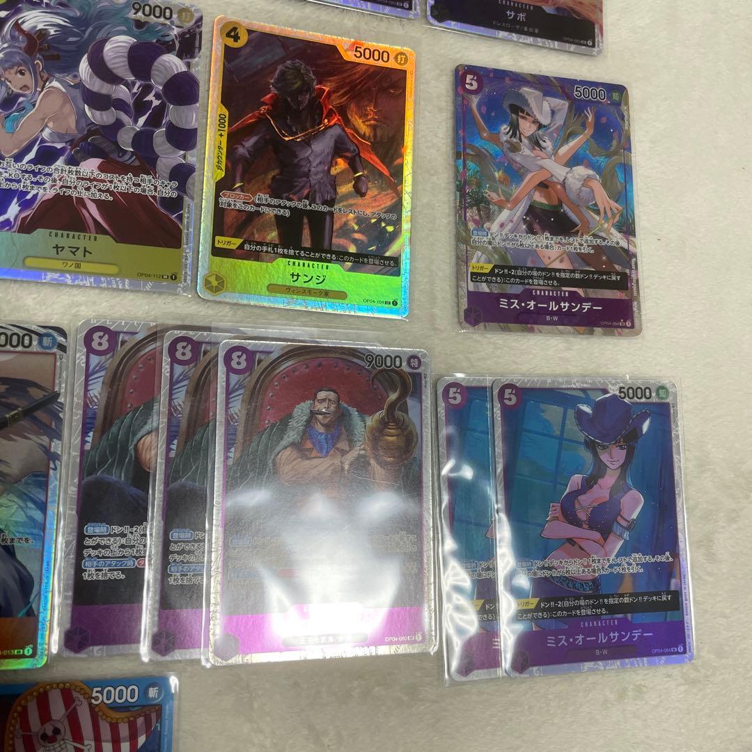 One Piece card set with Monkey D. Luffy SR, Sabo SR, Shanks R, and other rare cards in protective sleeves