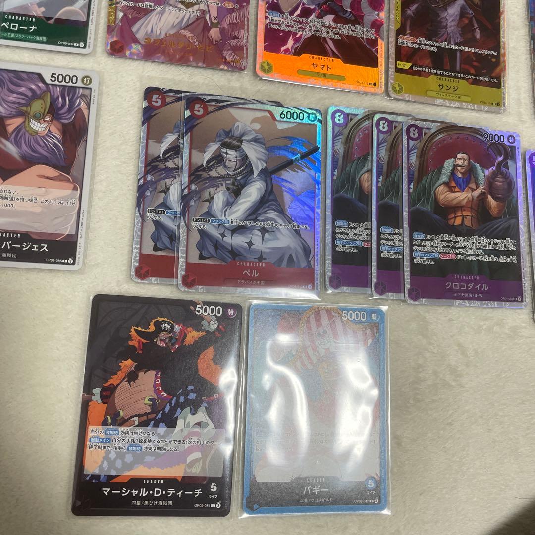 One Piece card set with Monkey D. Luffy SR, Sabo SR, Shanks R, and other rare cards in protective sleeves