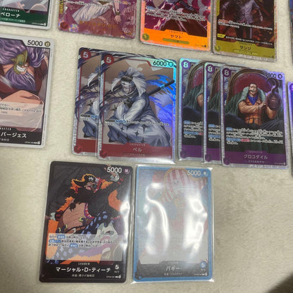 One Piece card set with Monkey D. Luffy SR, Sabo SR, Shanks R, and other rare cards in protective sleeves