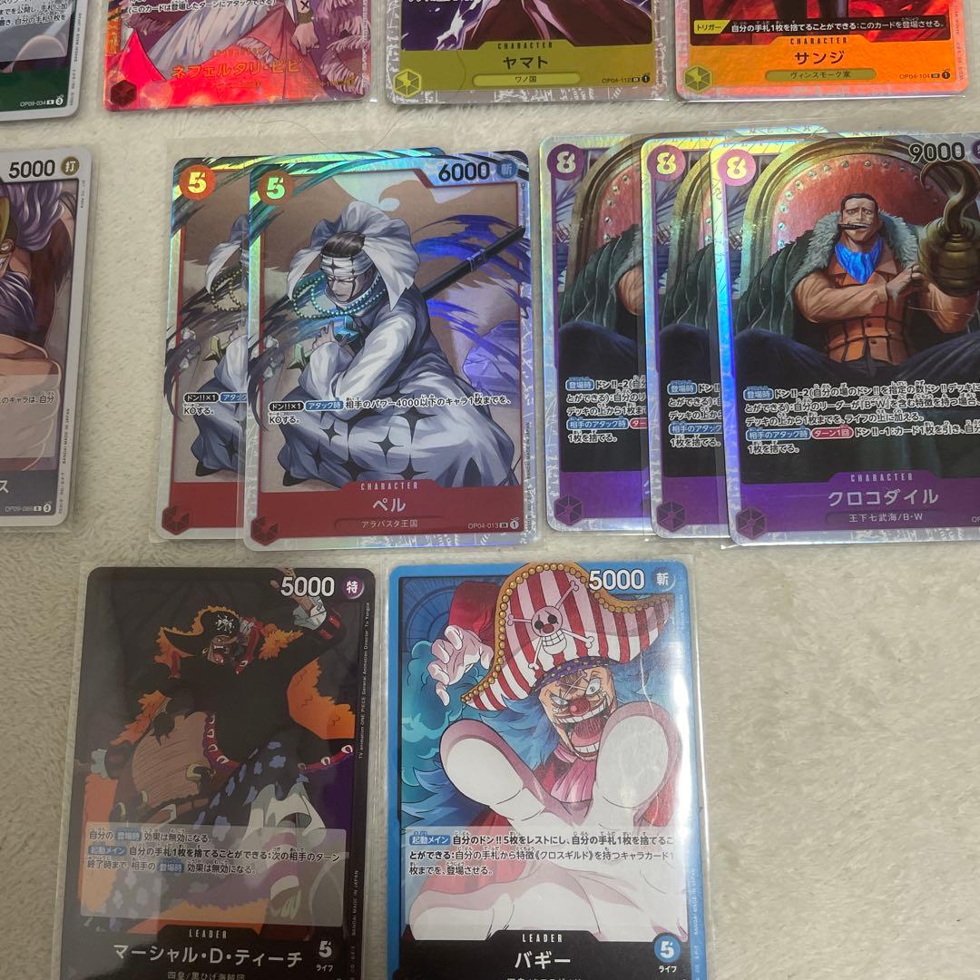 One Piece card set with Monkey D. Luffy SR, Sabo SR, Shanks R, and other rare cards in protective sleeves