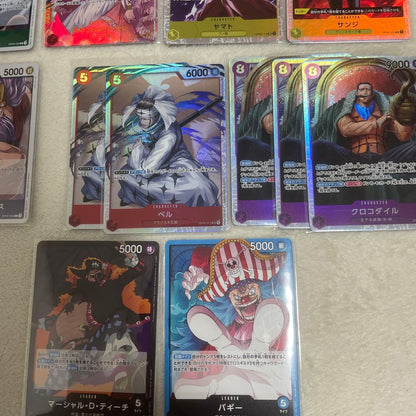 One Piece card set with Monkey D. Luffy SR, Sabo SR, Shanks R, and other rare cards in protective sleeves