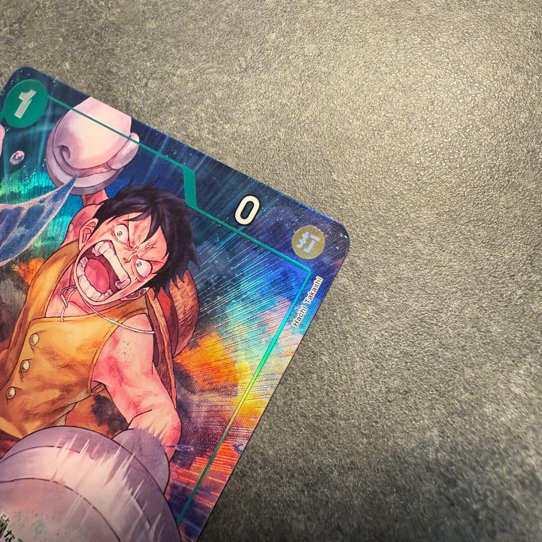 One Piece Monkey D. Luffy OP16-034 trading card in protective sleeve