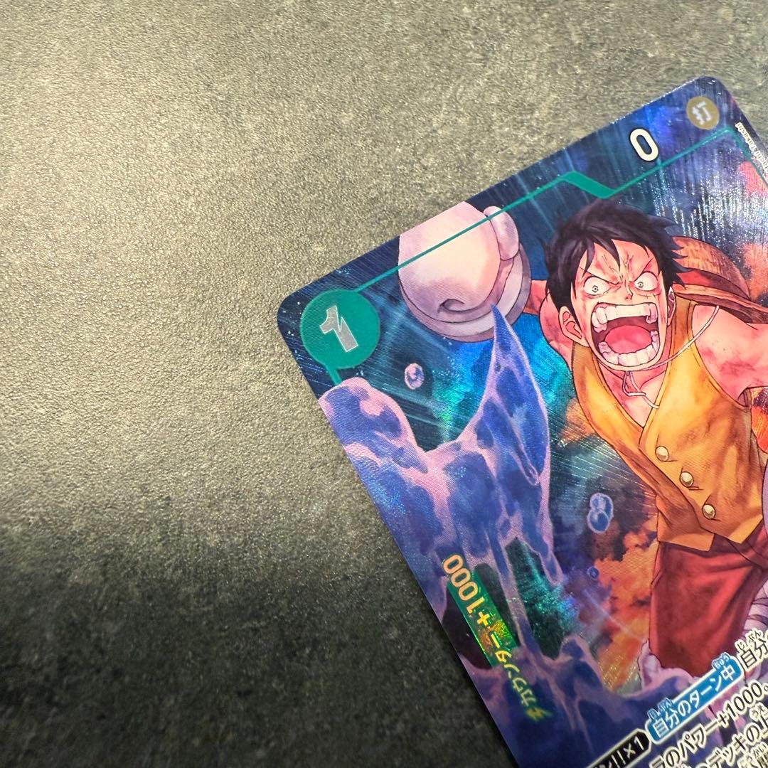 One Piece Monkey D. Luffy OP16-034 trading card in protective sleeve