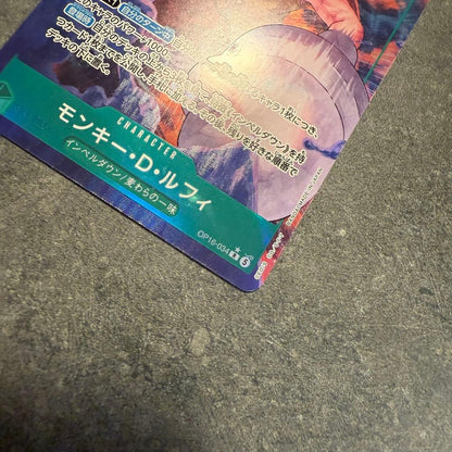 One Piece Monkey D. Luffy OP16-034 trading card in protective sleeve